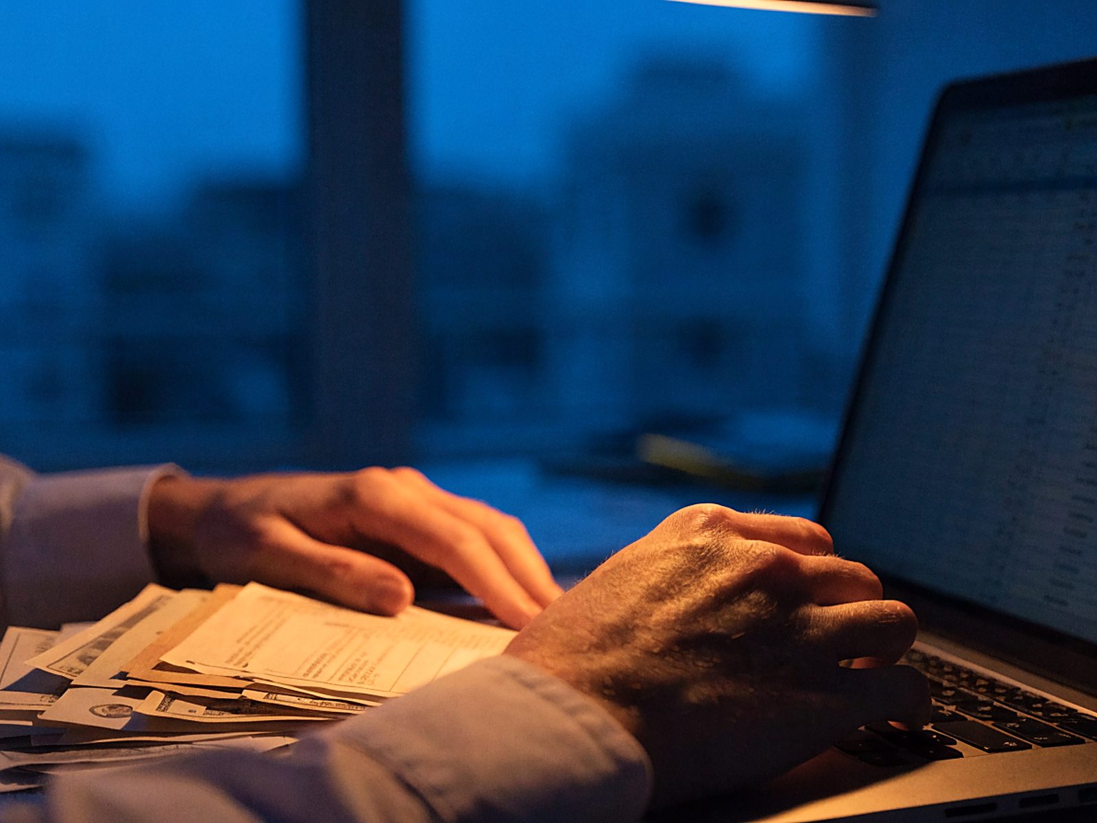 A budget being worked through step by step, bills and banking app side by side