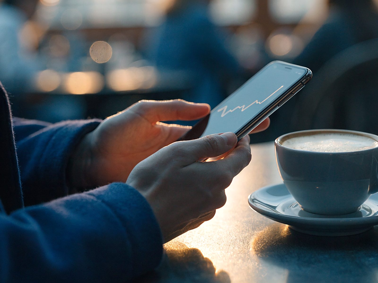 A person checking their progress on their phone, savings quietly building